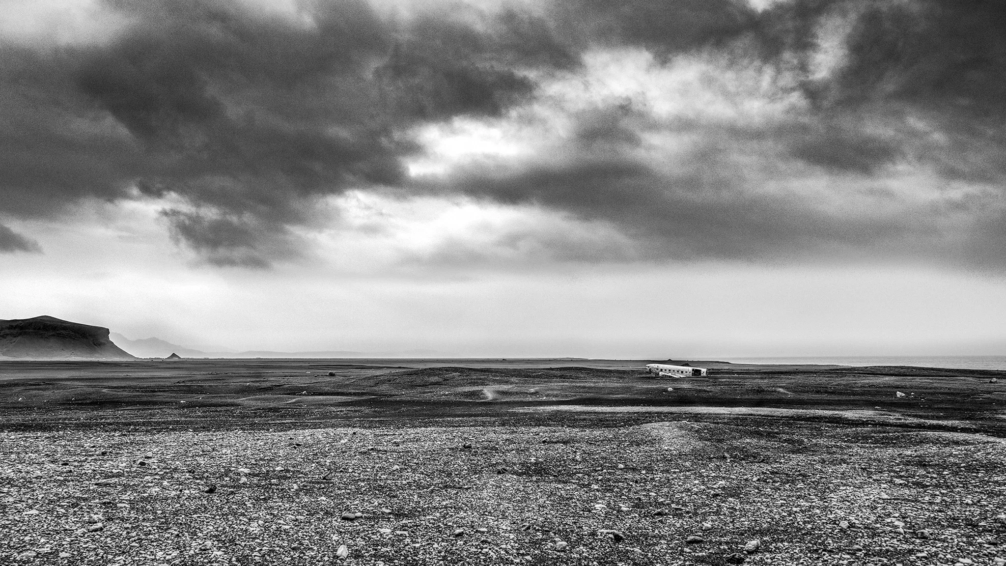 Crashed Plane, Iceland — abandoned aircraft in desolate open terrain, overcast sky
