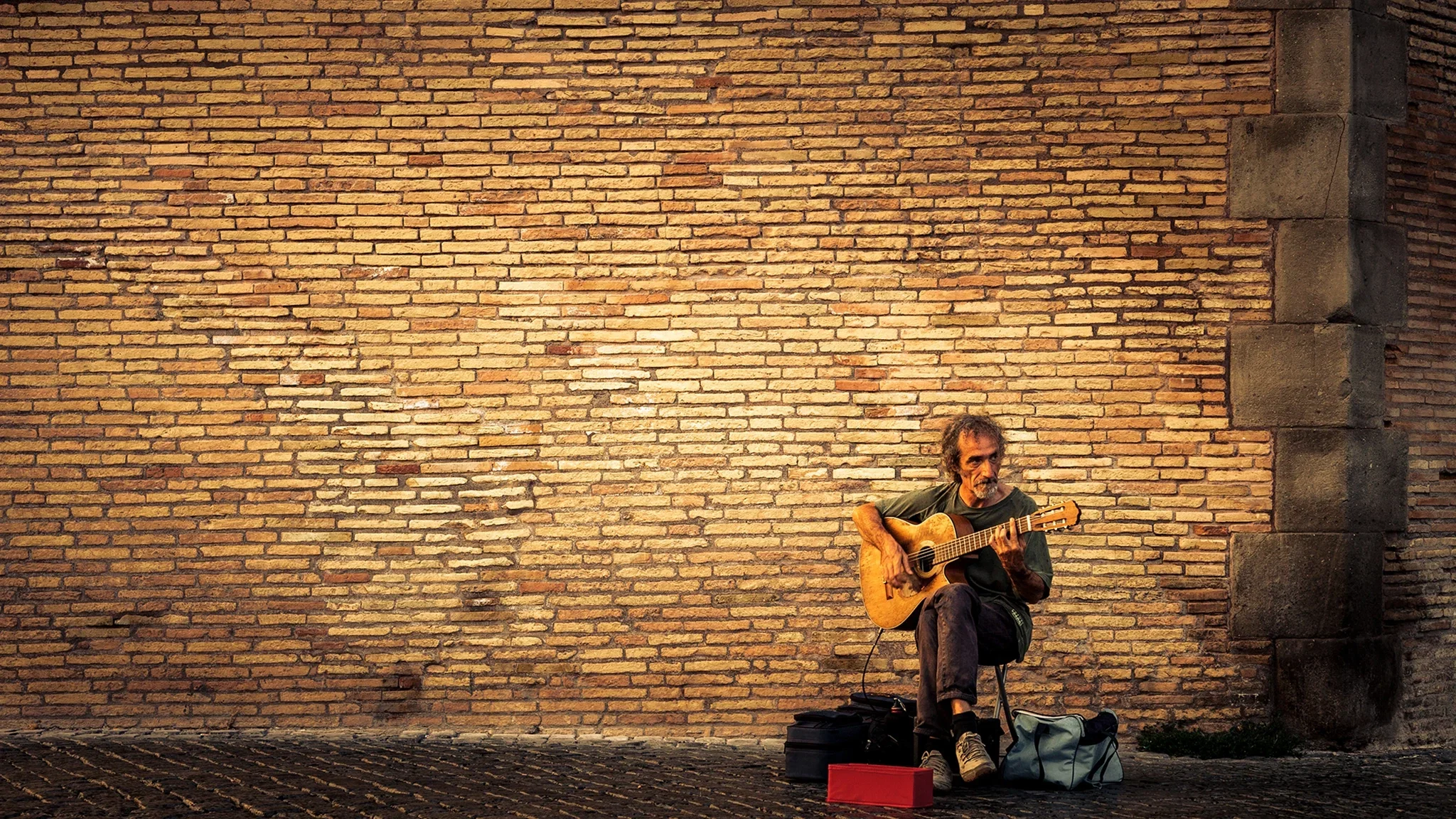 Street musician performing near the Saint Angelo Bridge, Rome — editorial portrait