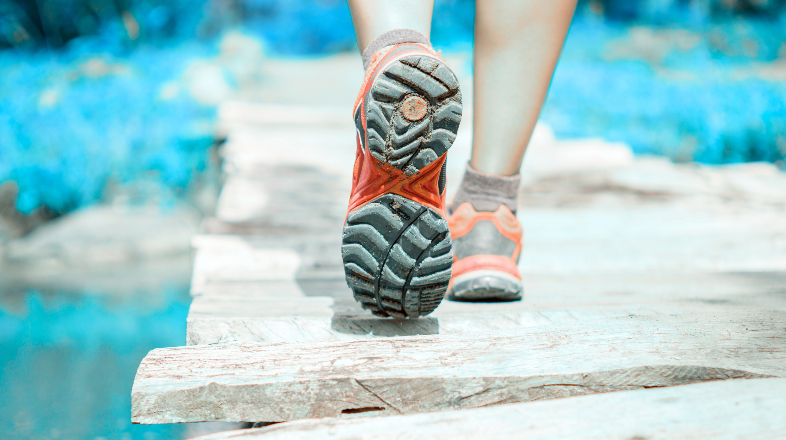 Close-up of running shoes crossing a bridge, representing the Lace Up Method and a strategic path to marketing growth.