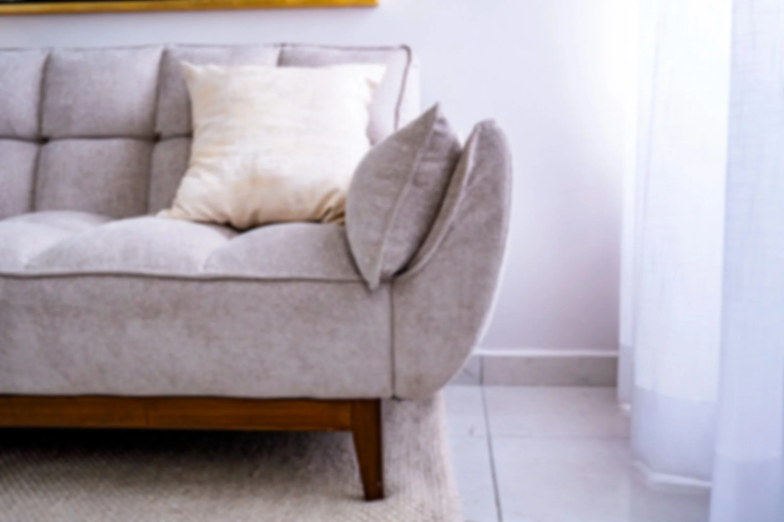 Sofá beige con cojines blancos