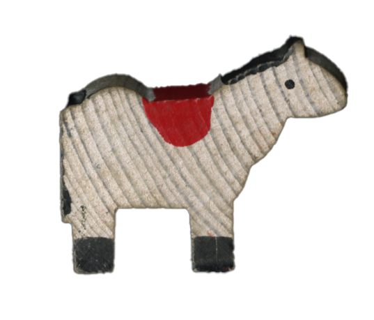 Toy dog with a striped pattern, red patches, and a small black eye.