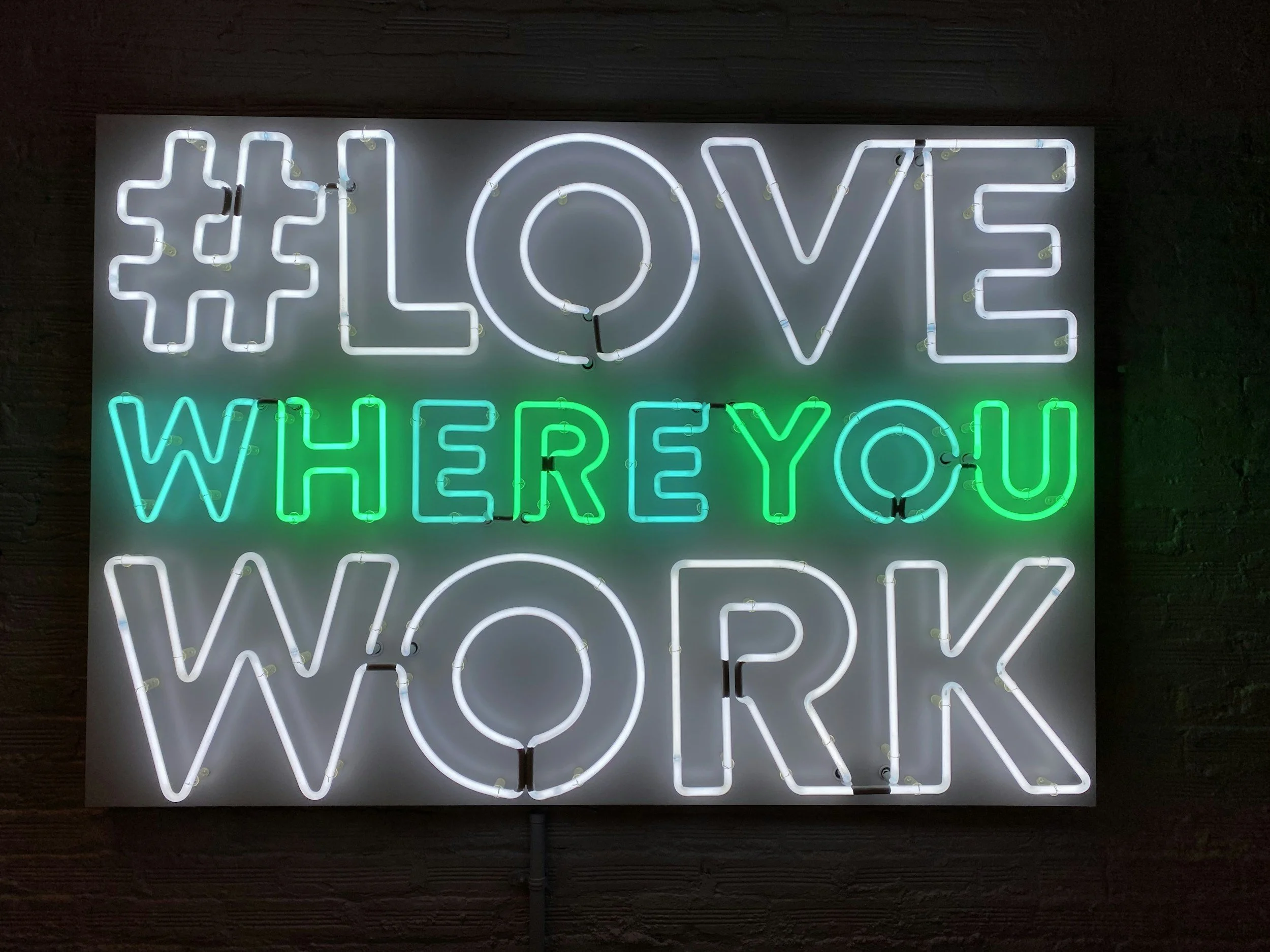 Neon sign with the hashtag #LOVE and the phrase WHERE YOU WANDER