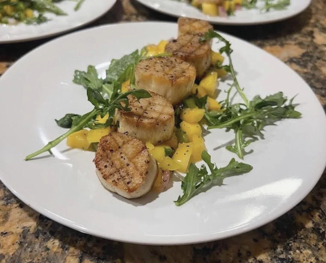 King Trumpet Scallops: Plant-based king trumpet mushroom scallops plated with mango salsa, and fresh arugula.
