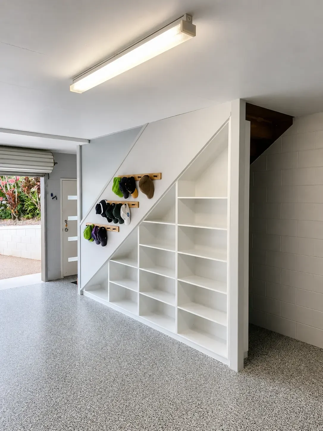 Custom under-stair storage with open shelving, hooks and practical entryway organisation.
