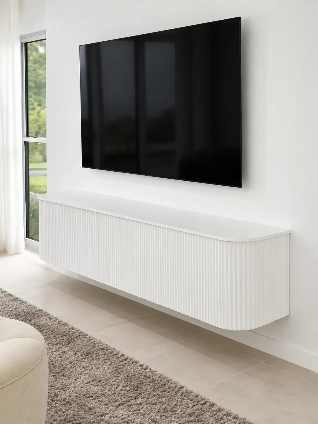 Wall-mounted white entertainment cabinetry beneath a flat-screen television.
