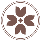 Tracy Thorne Acupuncture circular deep rose color flower logo with four stylized petals around a central dot