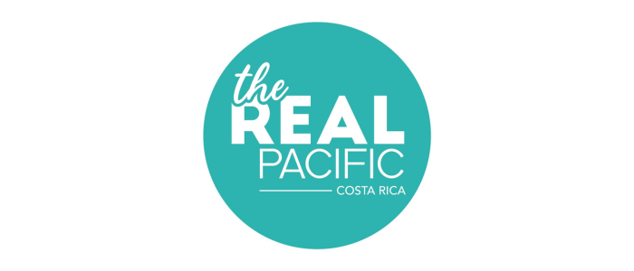 Logo with teal circle containing white text reading 'the REAL PACIFIC COSTA RICA'.