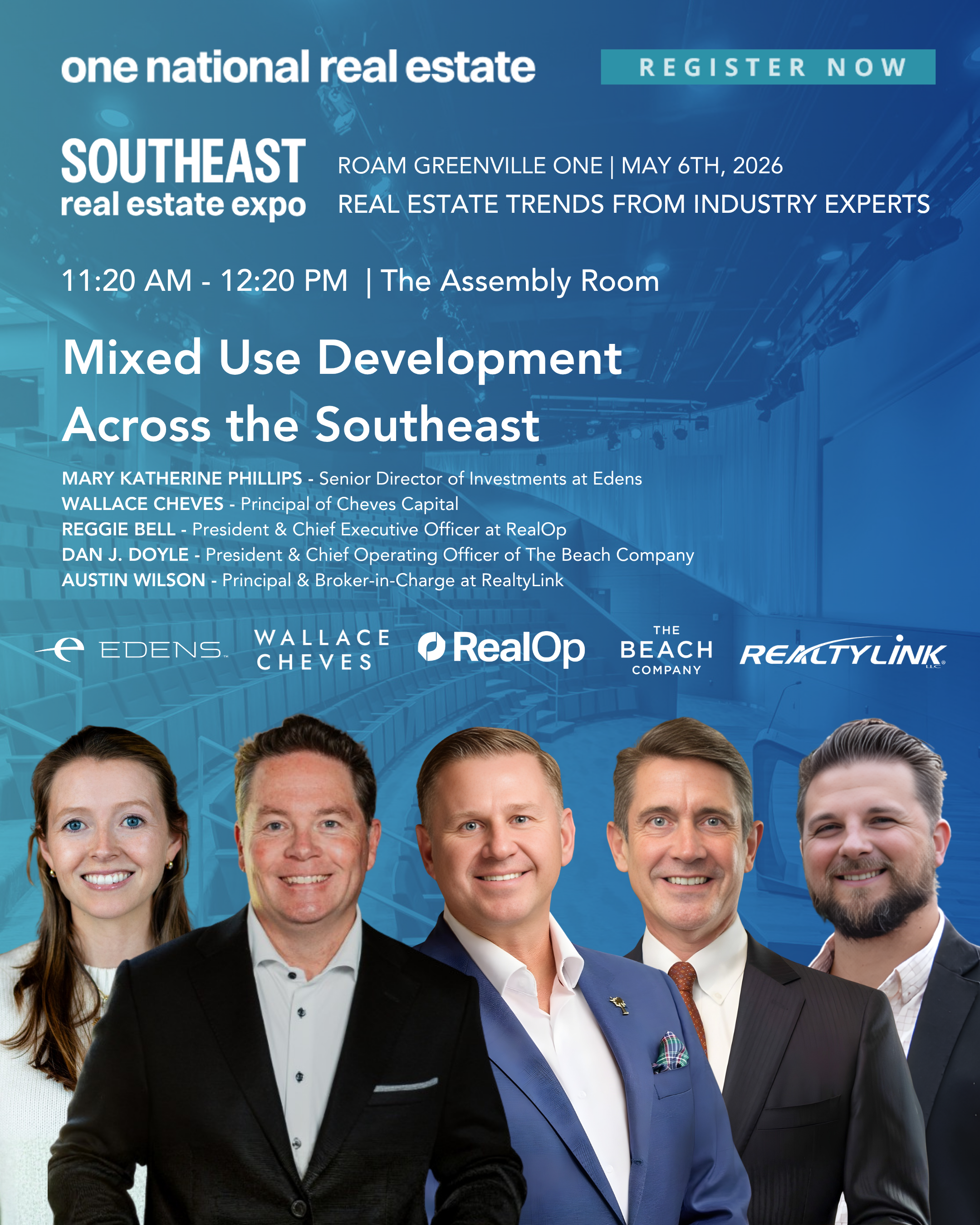 Group of professionals dressed in formal business attire smiling for a photo, with a blue background featuring the logos of real estate companies and a poster about a real estate expo.