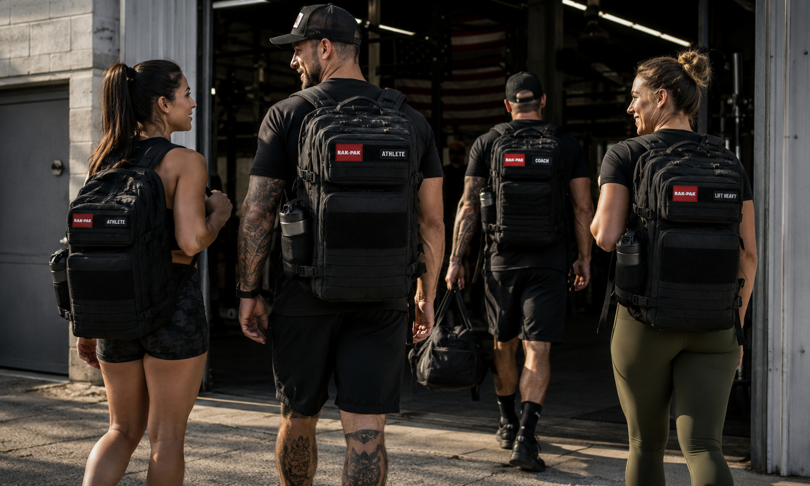 Four fit athletes with backpacks standing outside a gym, preparing to start their workout.