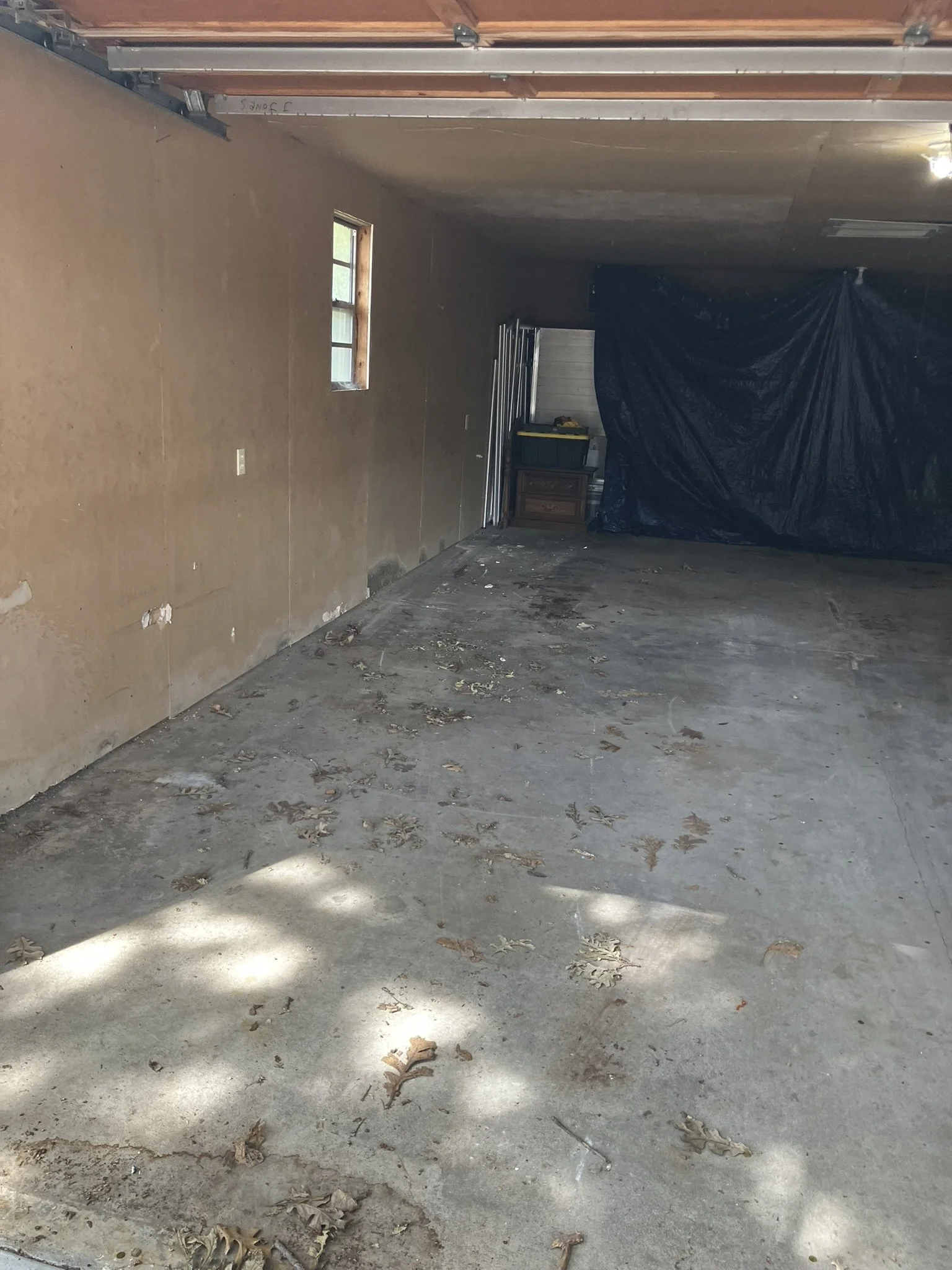 Garage cleared of unwanted furniture and household items, leaving a clean, open space ready for use after a complete junk removal by Junk Boys.