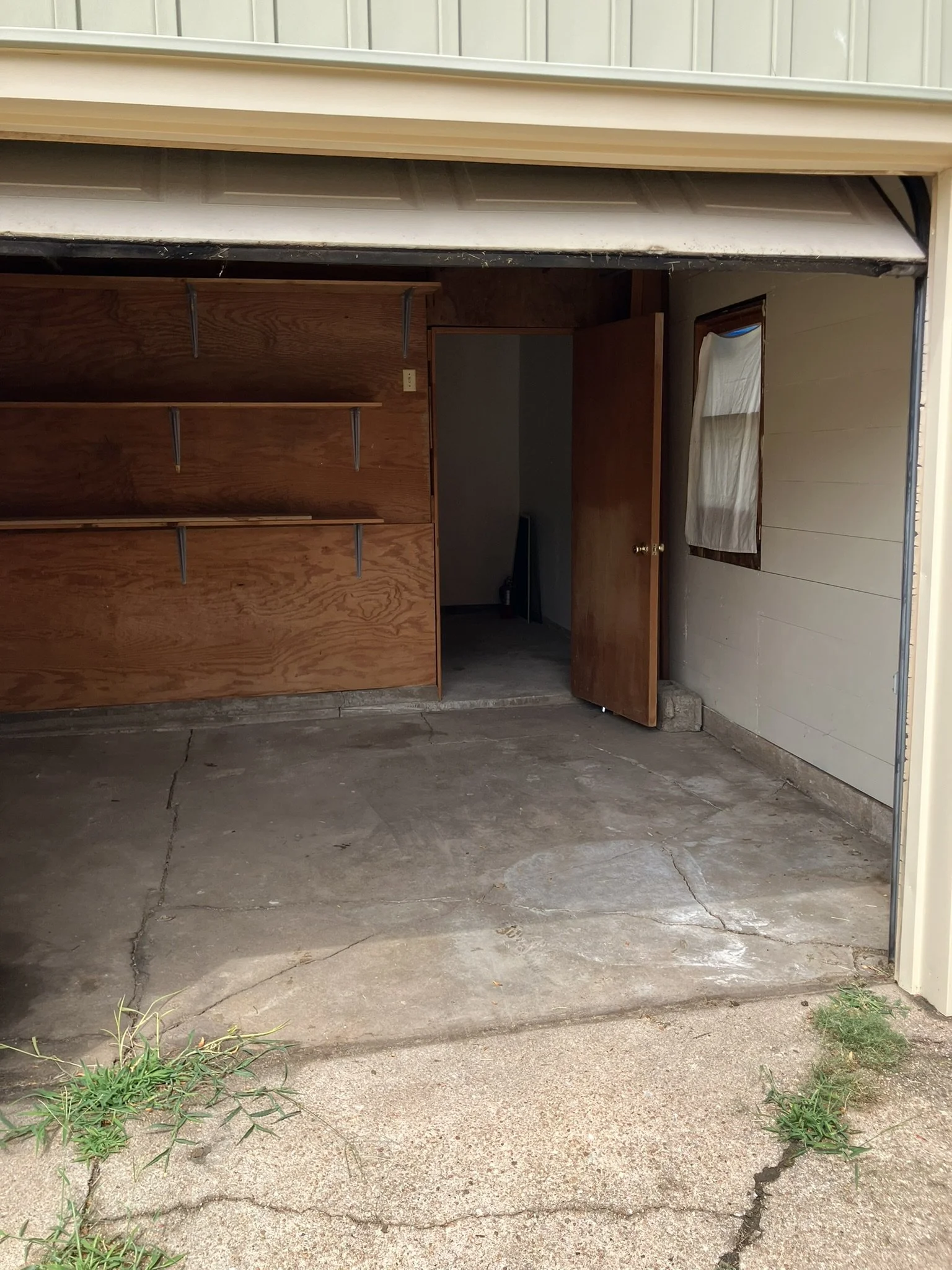 Clean, clutter-free garage after Junk Boys removed the unwanted furniture, boxes, and household junk, leaving the space open, organized, and ready to use.