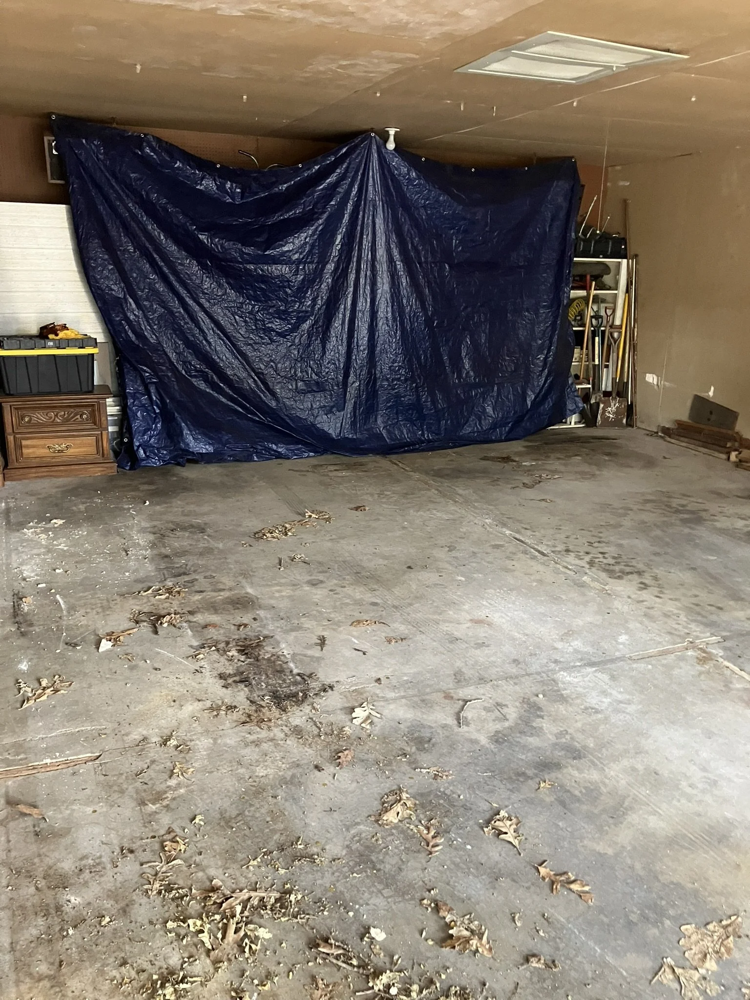 Clean, cleared out garage after Junk Boys removed unwanted carpet, furniture, and other debris, leaving the space open and ready to use.