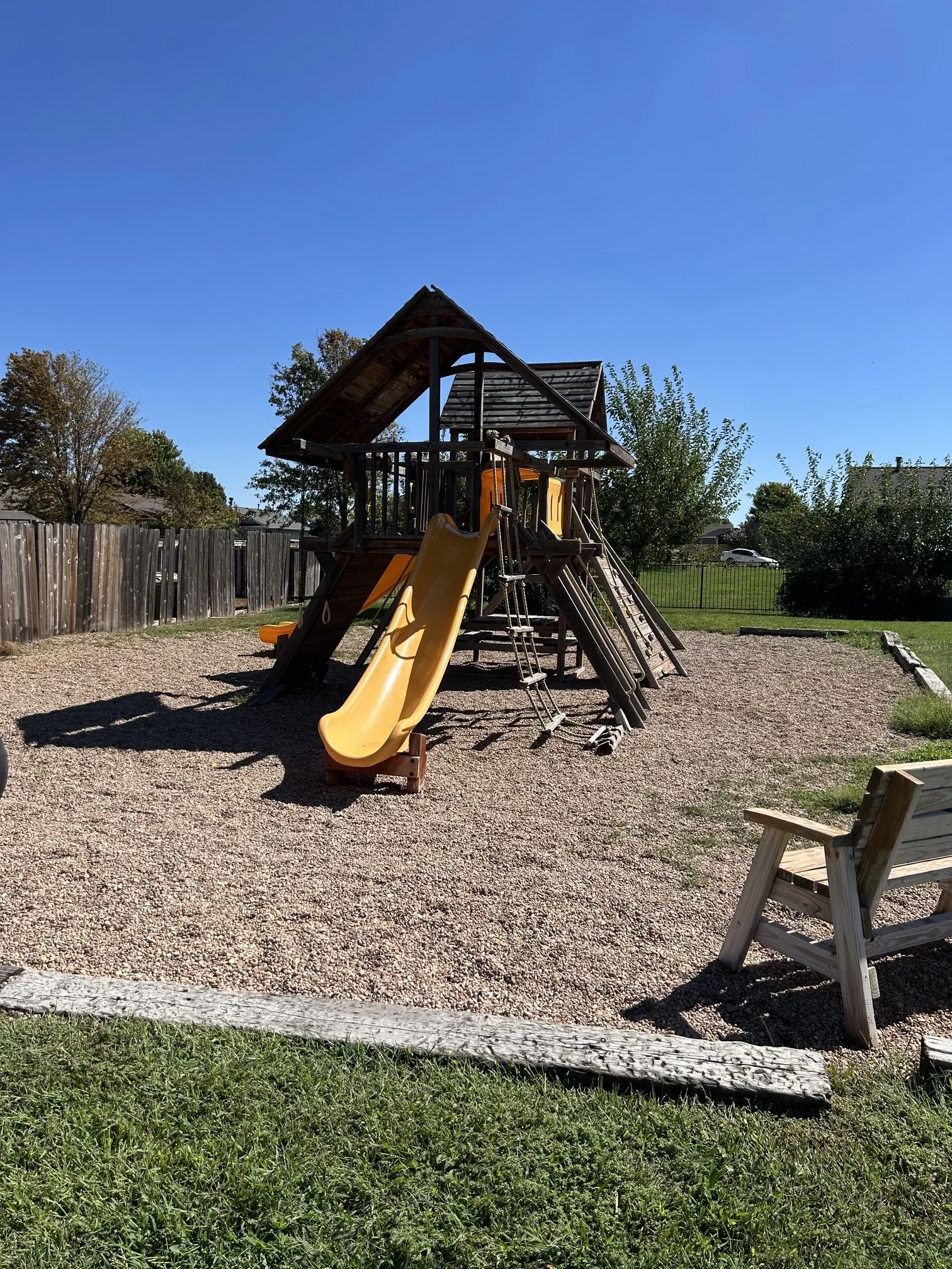 Large wooden playset before teardown and removal. Junk Boys handles the dismantling, heavy lifting, and haul-away of swing sets and playground equipment in Wichita and surrounding areas.