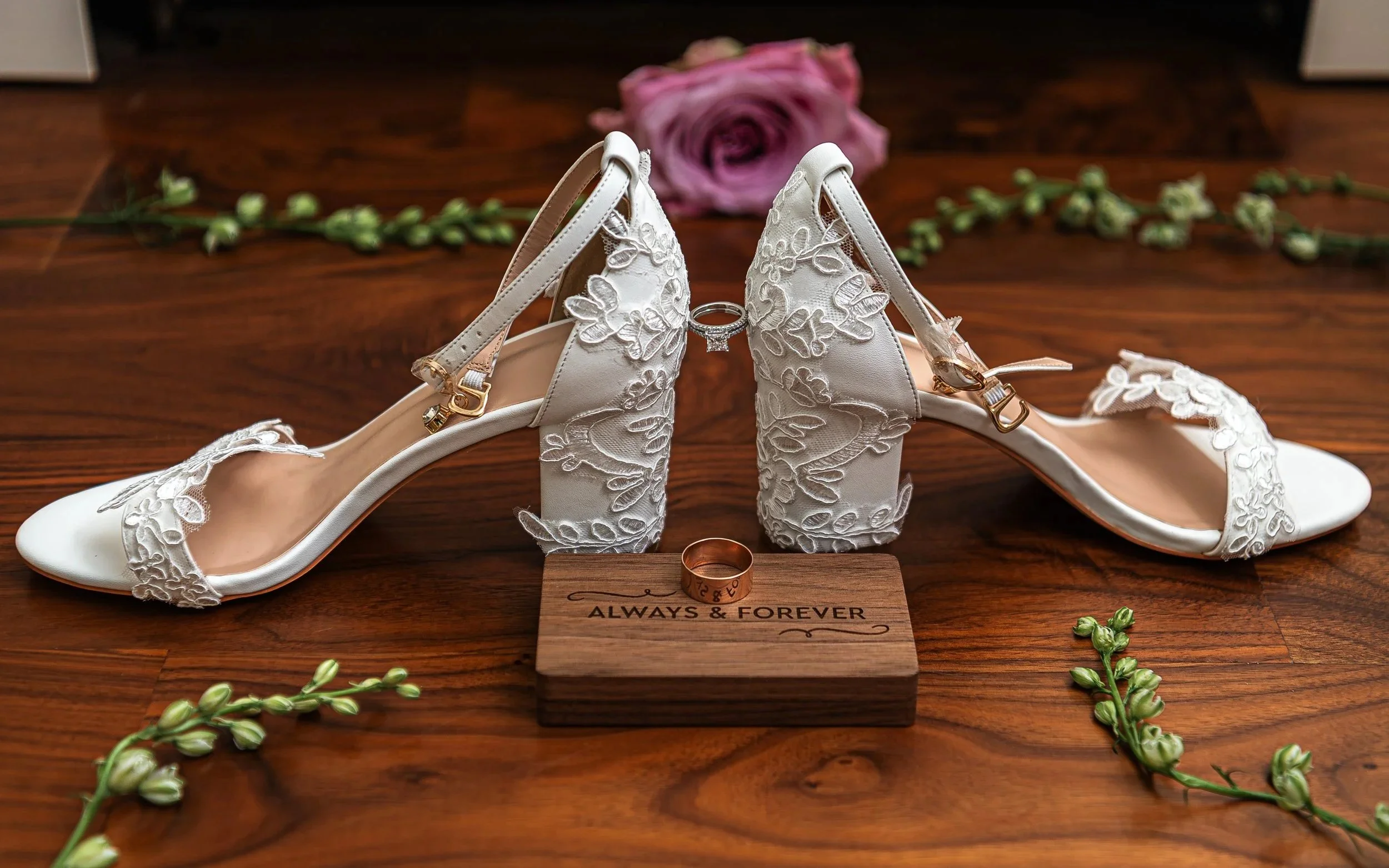 Bridal shoes and wedding rings arranged on a hardwood floor at Drumore Estate, Pequea, PA