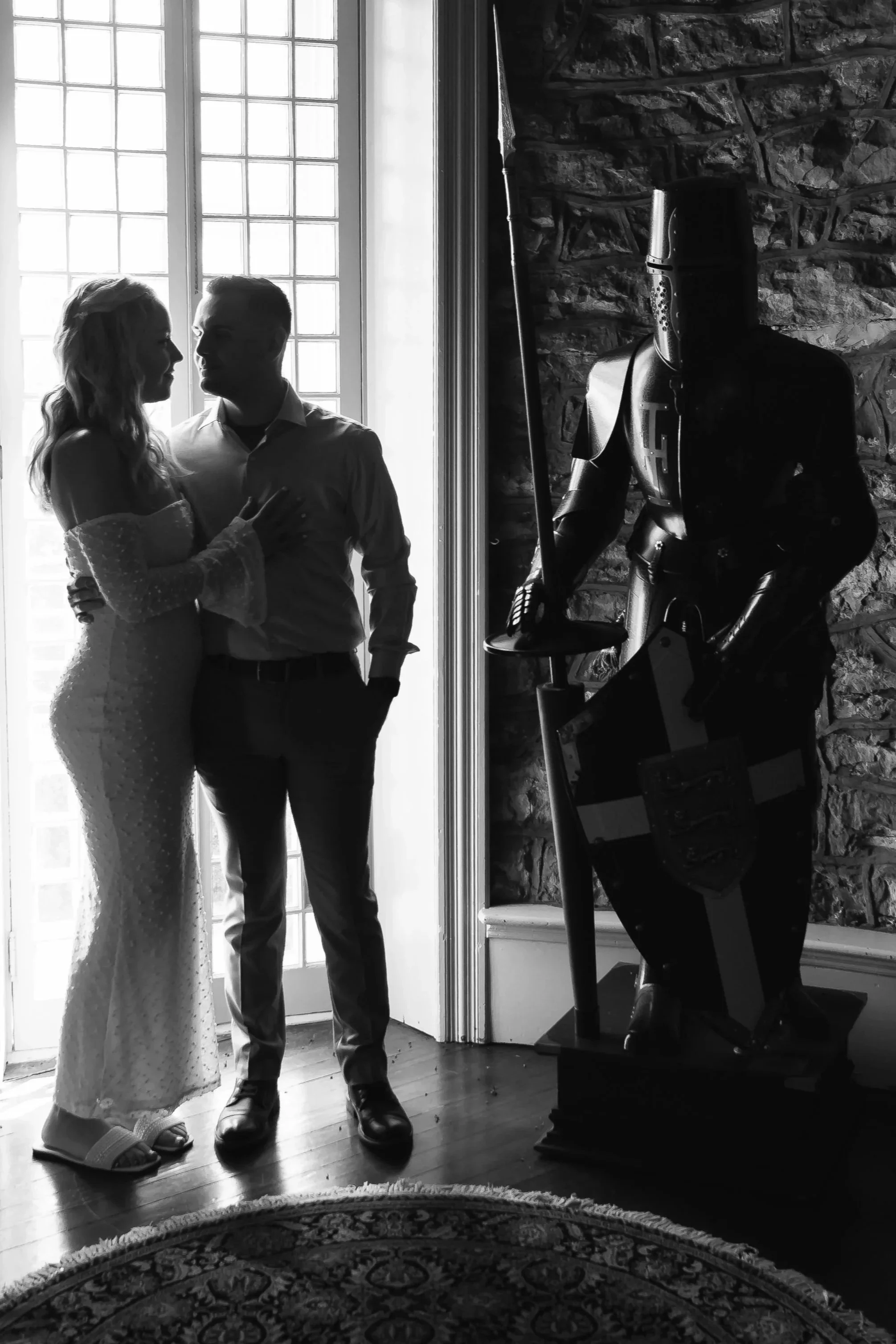 Engaged couple kissing outside Berkeley Castle in Berkeley Springs, WV