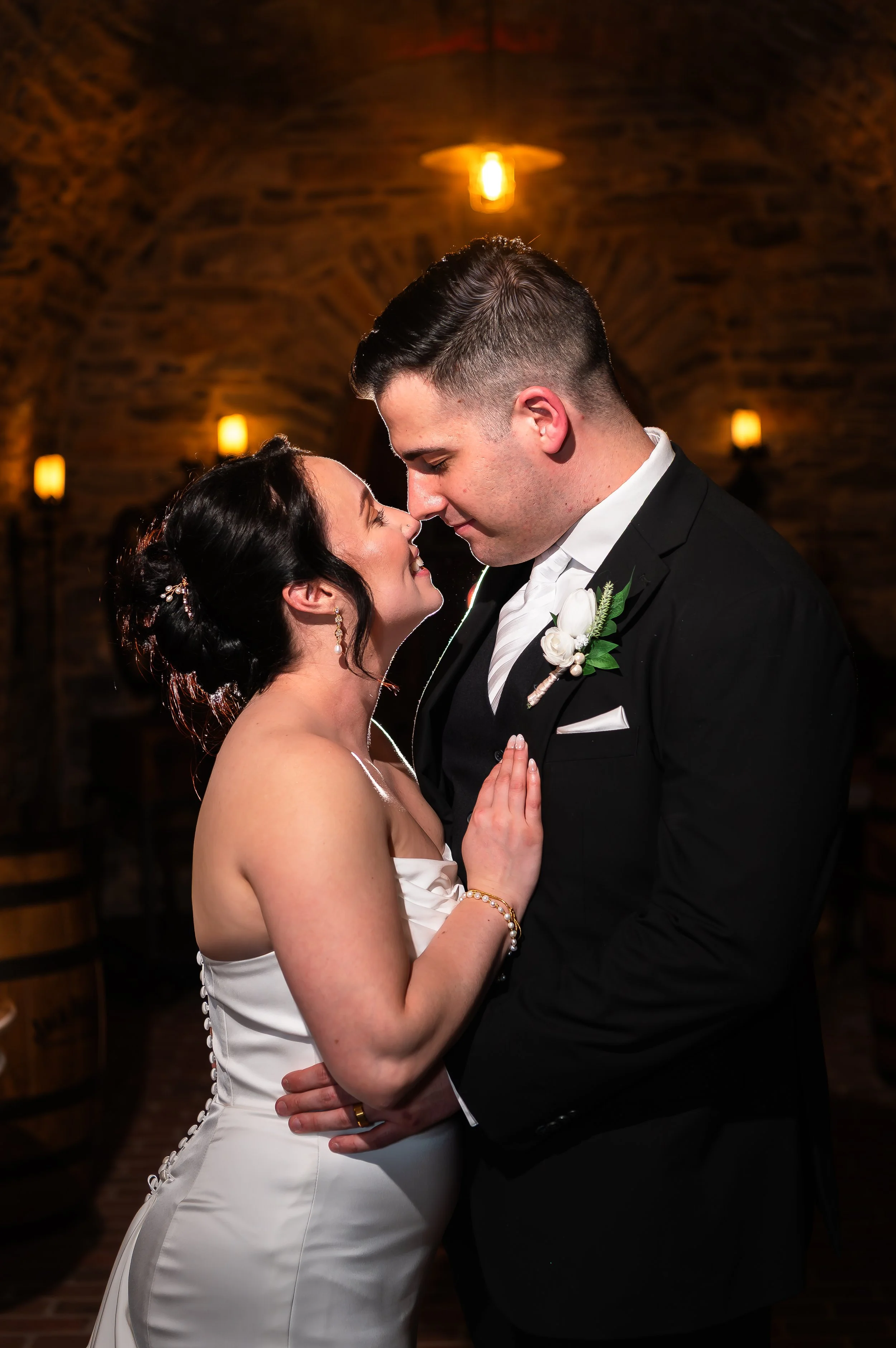 Bride and groom sharing a first dance at Stone Gables Estate's Star Barn in Elizabethtown, PA, warm lighting and stone walls.