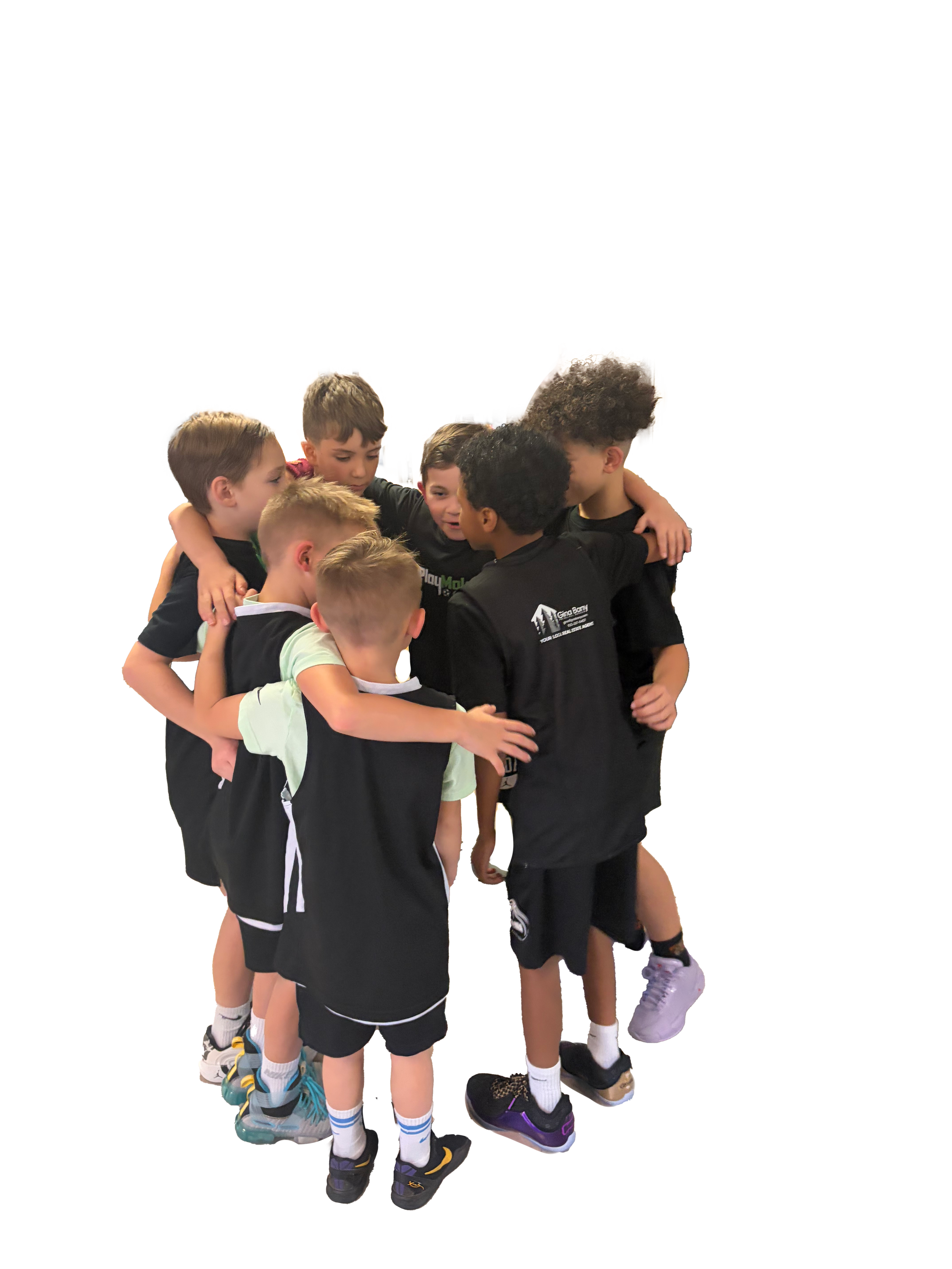 A group of young boys wearing sports uniforms hugging each other.