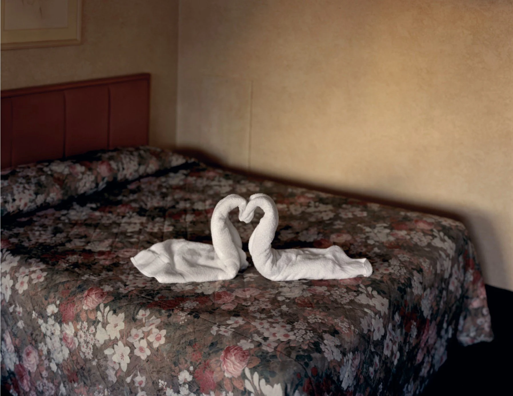 A bed in a motel room with towels