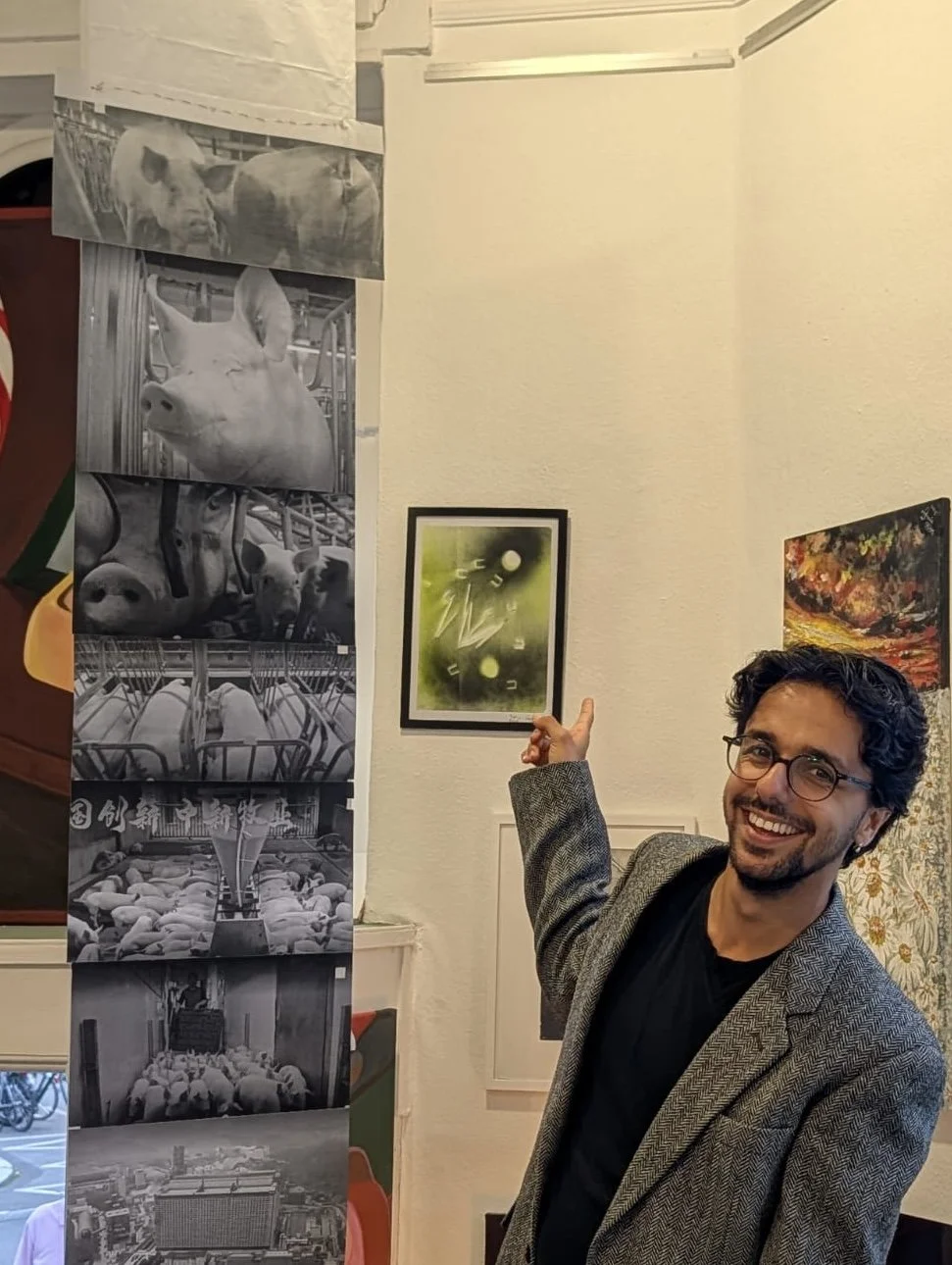 Me pointing at my work hanging on the wall