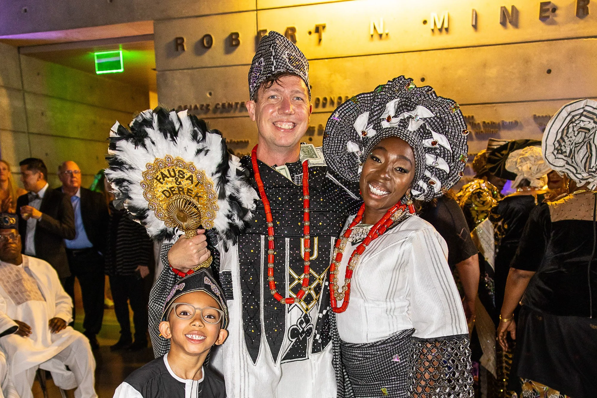 Guests in elaborate feathered headdresses at a themed private celebration in San Francisco