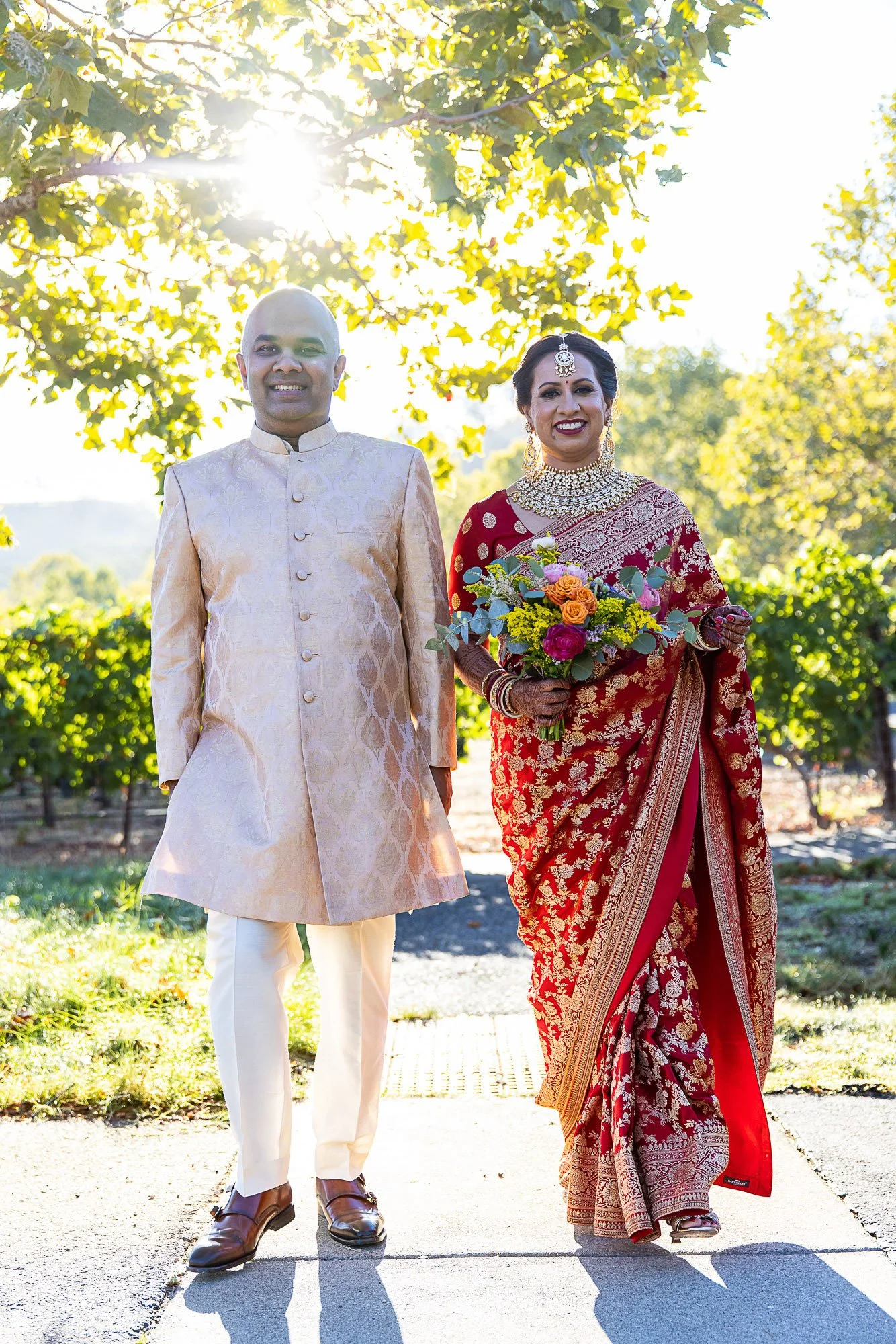 Bride and groom walking the vineyard at Wente Winery, Livermore
