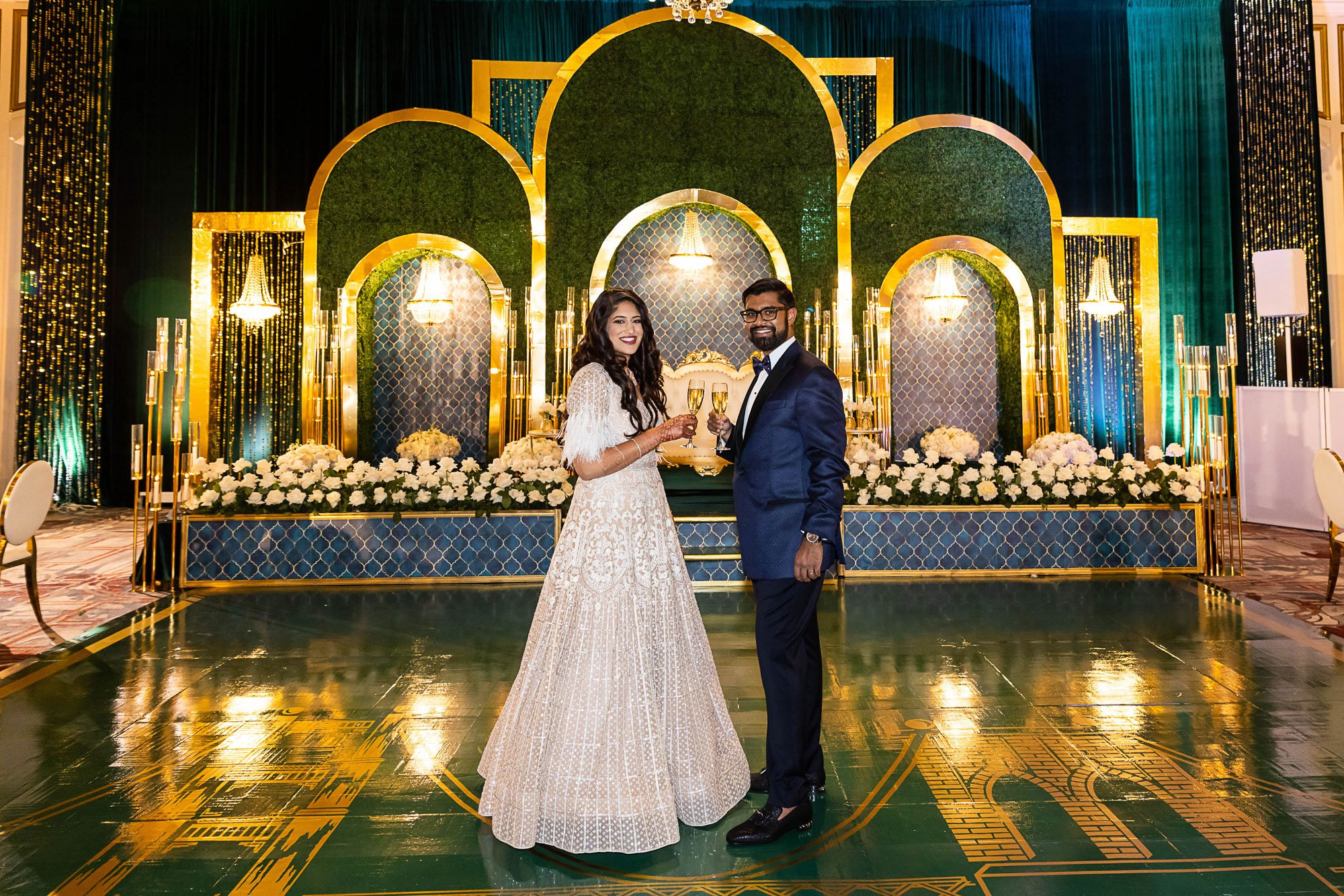 Bride and groom toasting on the reception dance floor at the Palace Hotel, San Francisco