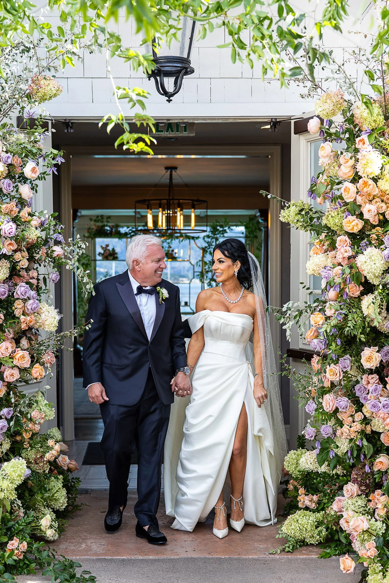 Couple in a flower-covered doorway at Pebble Beach Resorts