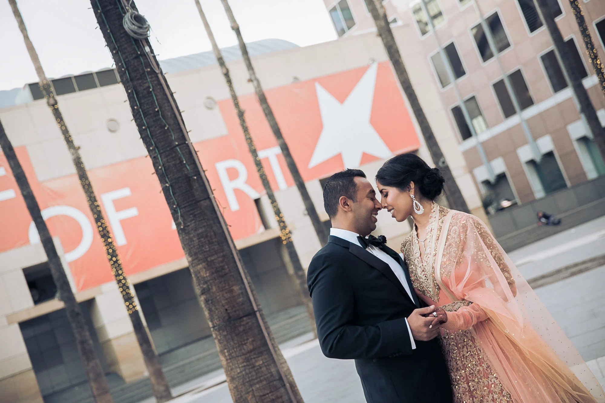 Bride and groom forehead to forehead outside the Fairmont Hotel in downtown San Jose