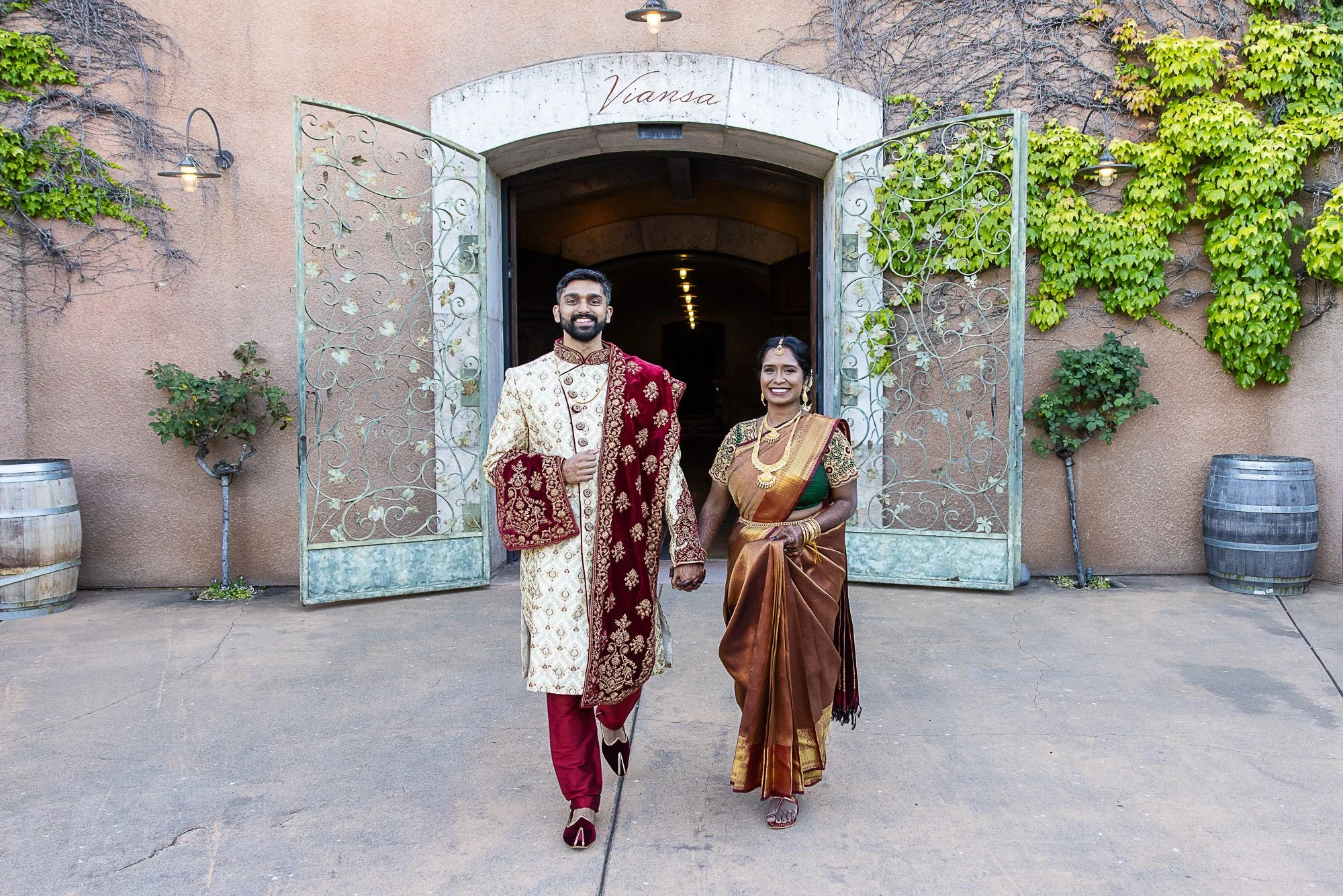 Bride and groom leaving the ivy-covered entrance at Viansa Winery, Sonoma