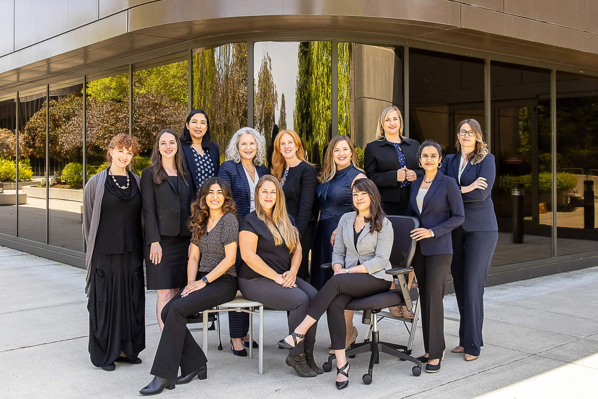 Team portrait of a company's staff outside their office building
