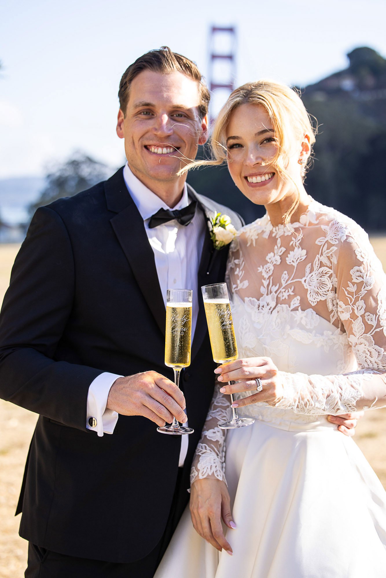 Couple toasting with champagne at Cavallo Point, with the Golden Gate Bridge behind them