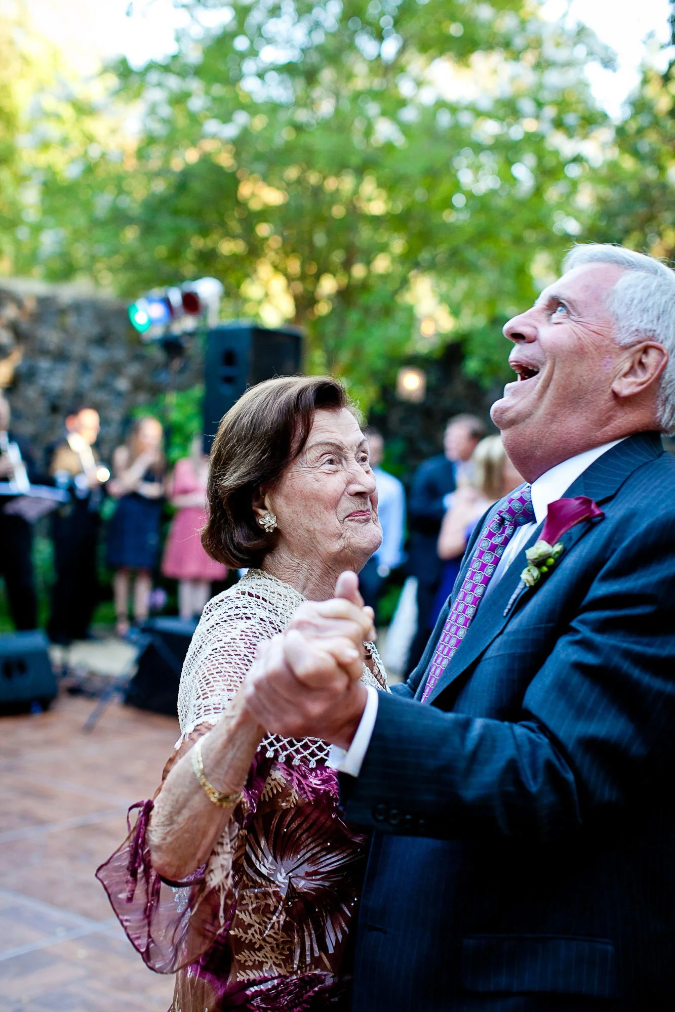 Parents of the bride laughing together on the dance floor