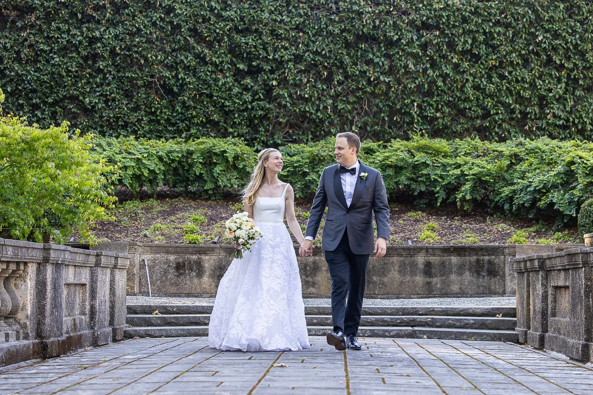 Bride and groom walking the garden terrace at Burlingame Country Club