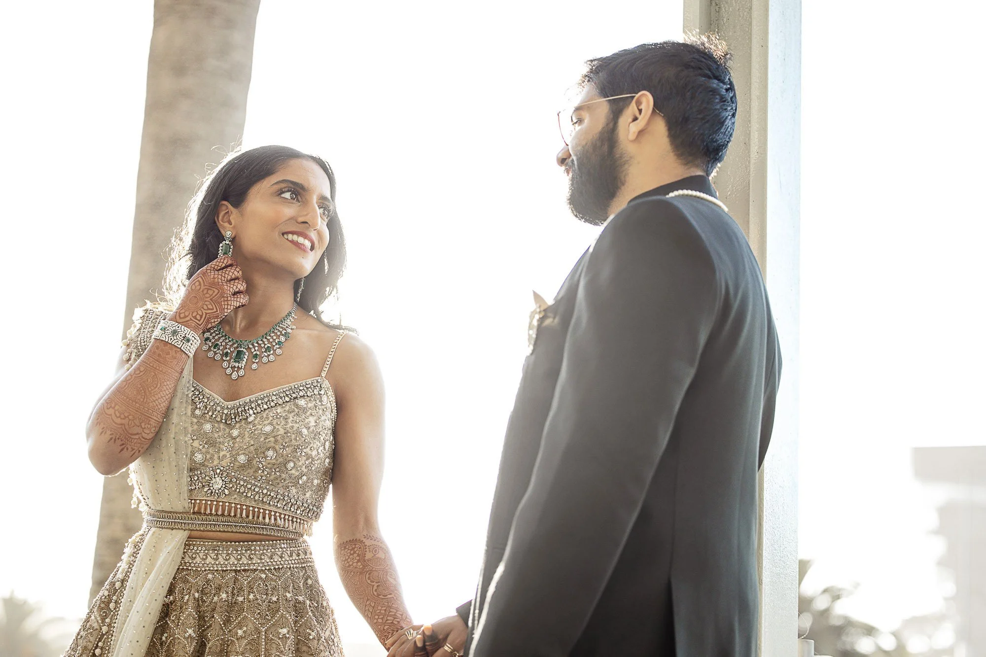 Indian bride and groom holding hands in the Botanical Gardens at the California Academy of Sciences