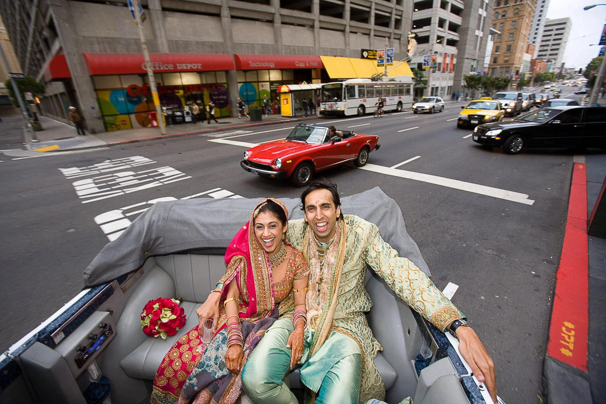 Bride and groom laughing in the back of a convertible on a San Francisco street    Family Portraits Page 30 pages