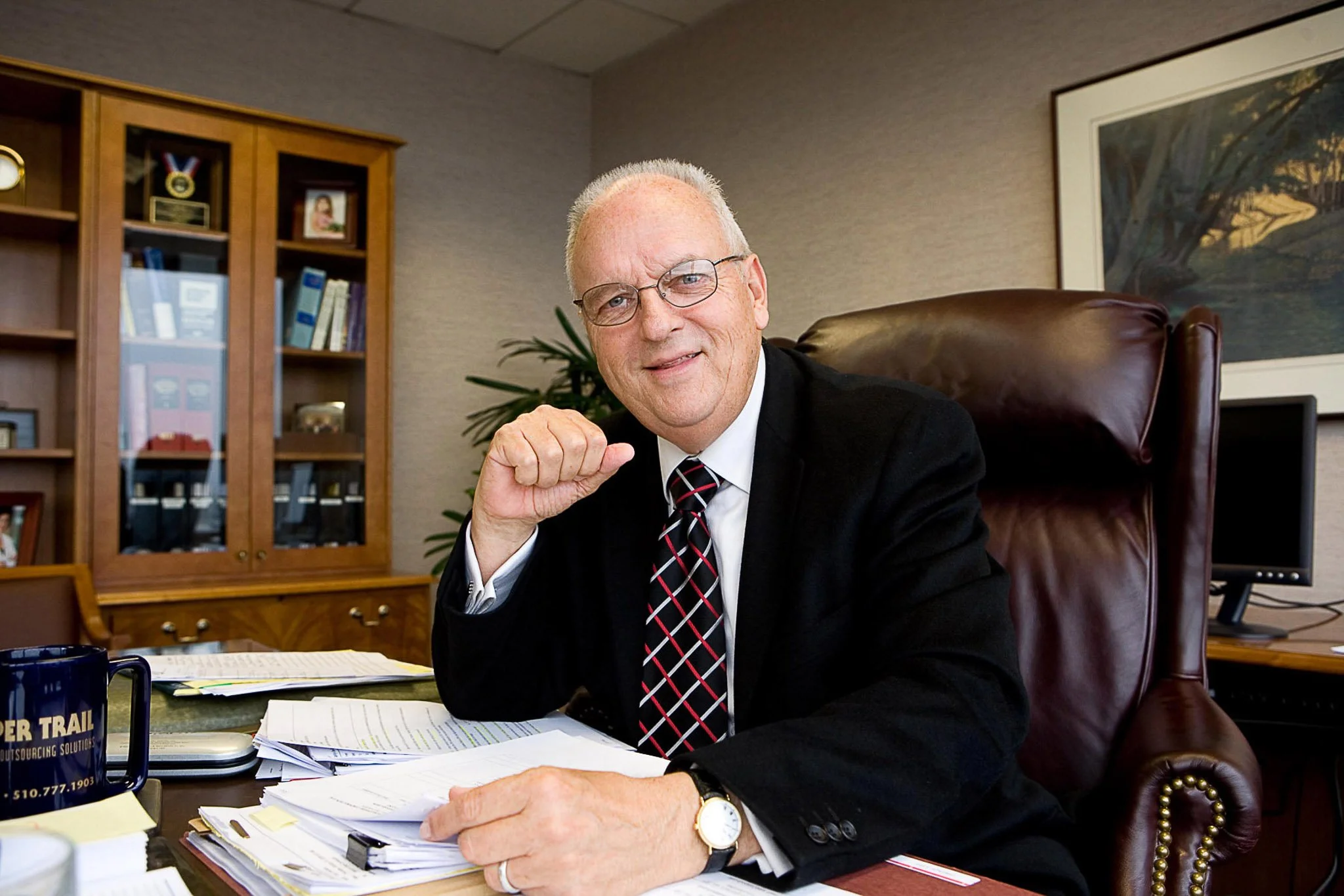 Executive portrait of a man at his desk in his office