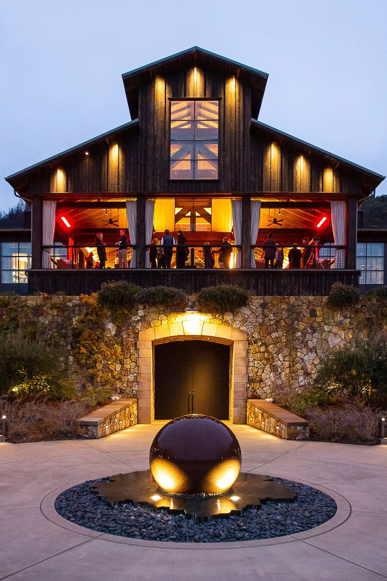 Evening exterior of a winery venue lit for a corporate event reception