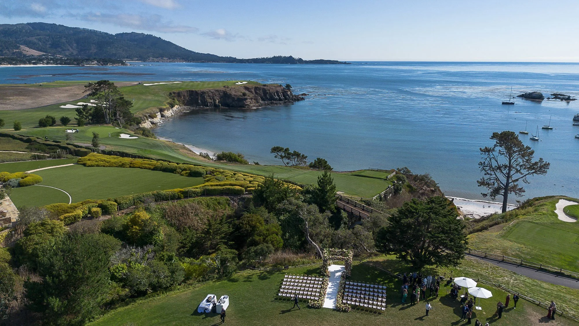 Aerial view of a cliffside wedding ceremony at The Beach Club, Pebble Beach, overlooking Stillwater Cove and the Pacific