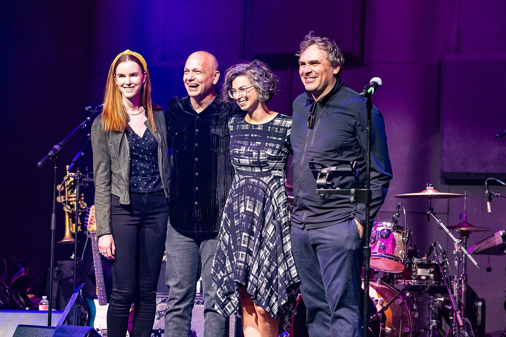 Musicians on stage at a book signing party in San Francisco