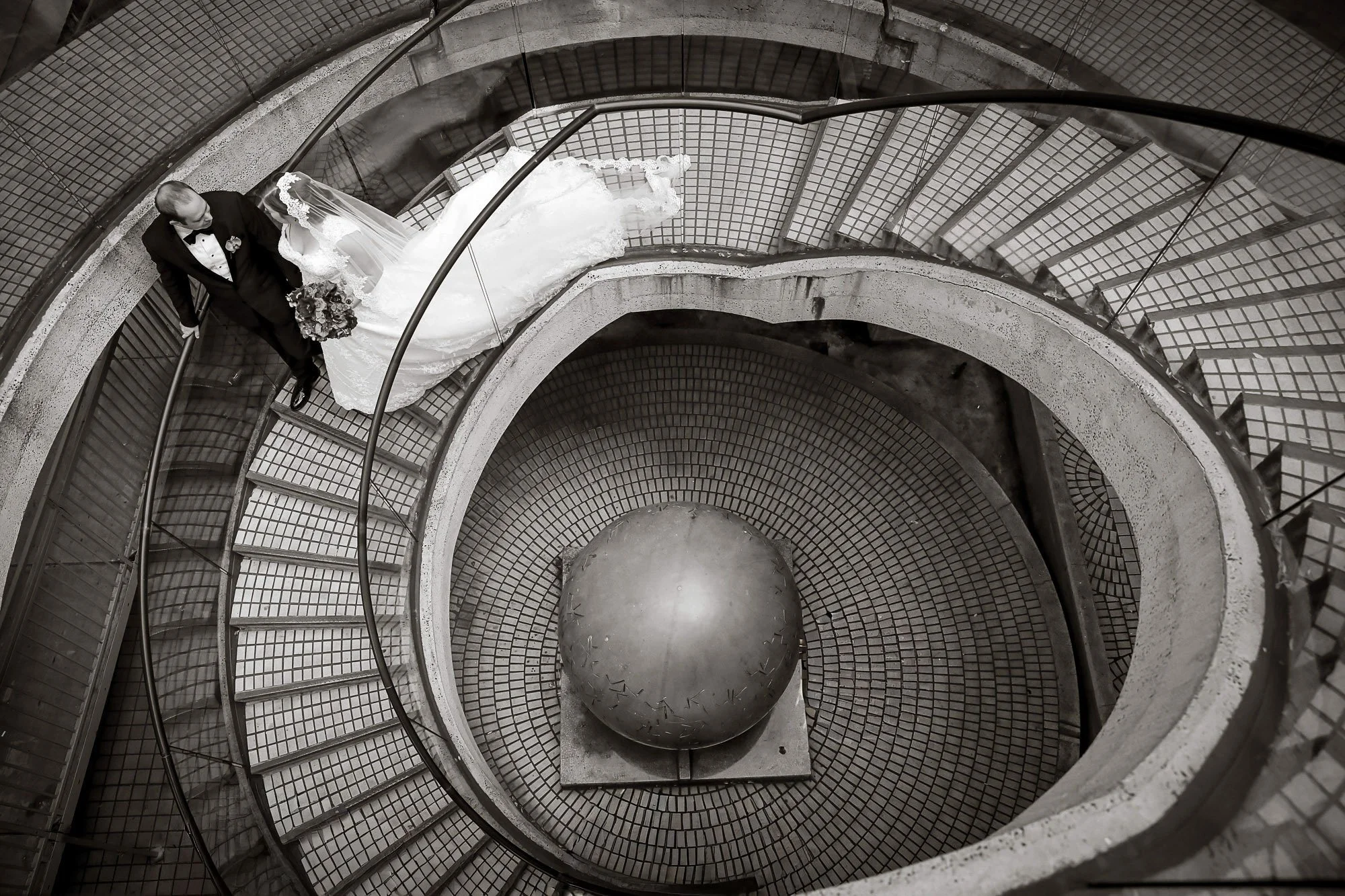 Couple portrait on a grand staircase at their San Francisco wedding