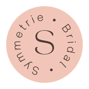 Circular logo with a pink background featuring the words 'Sunmetrie Bridal' around the central letter 'S'.