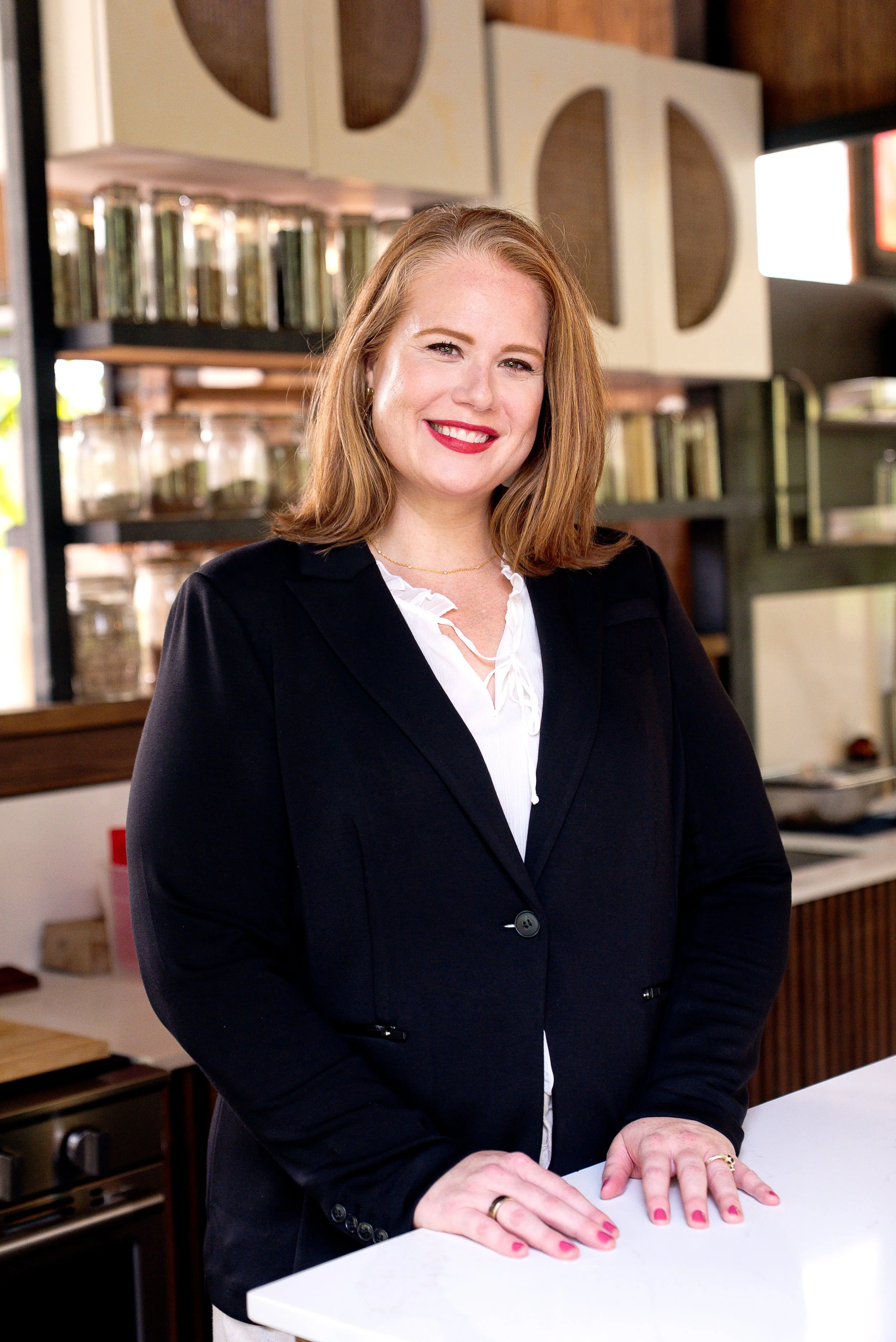 Fern and Stone Founder Ashley smiling at camera in business attire