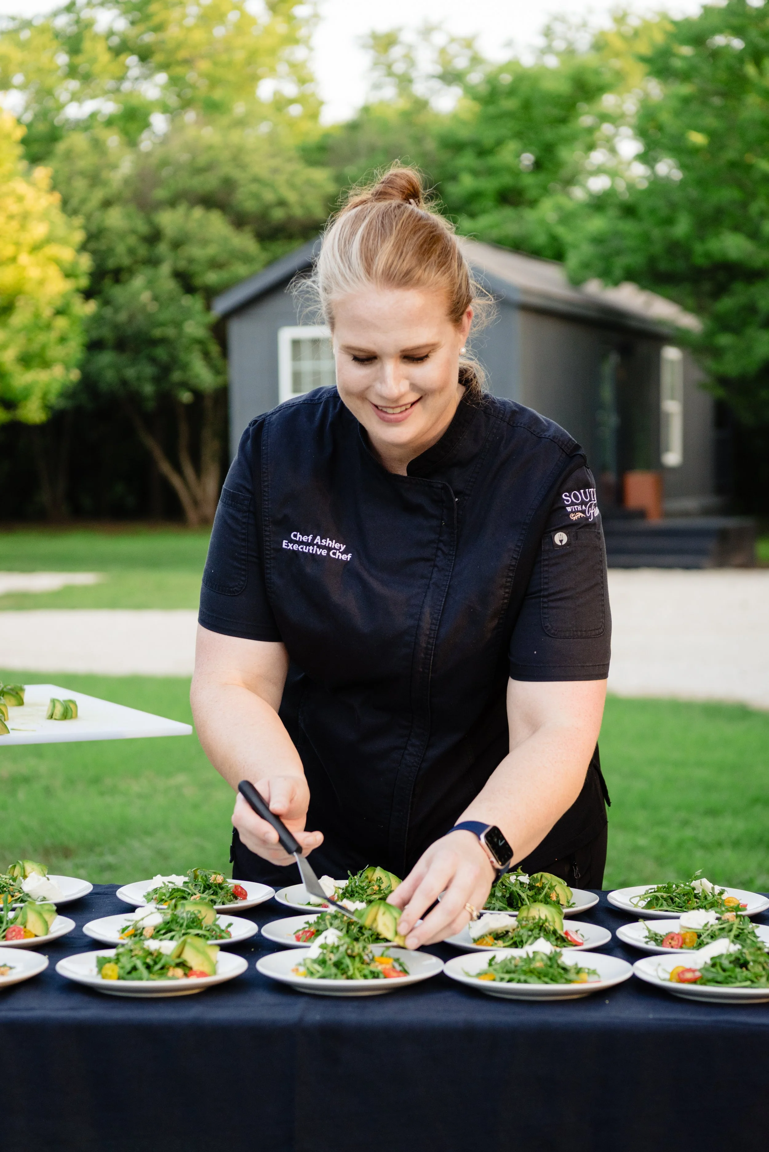 Fern and stone founder smiling and plating food