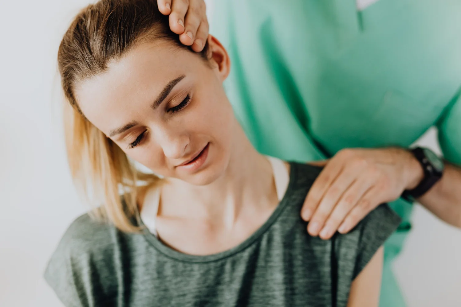 Person experiencing neck pain while sitting