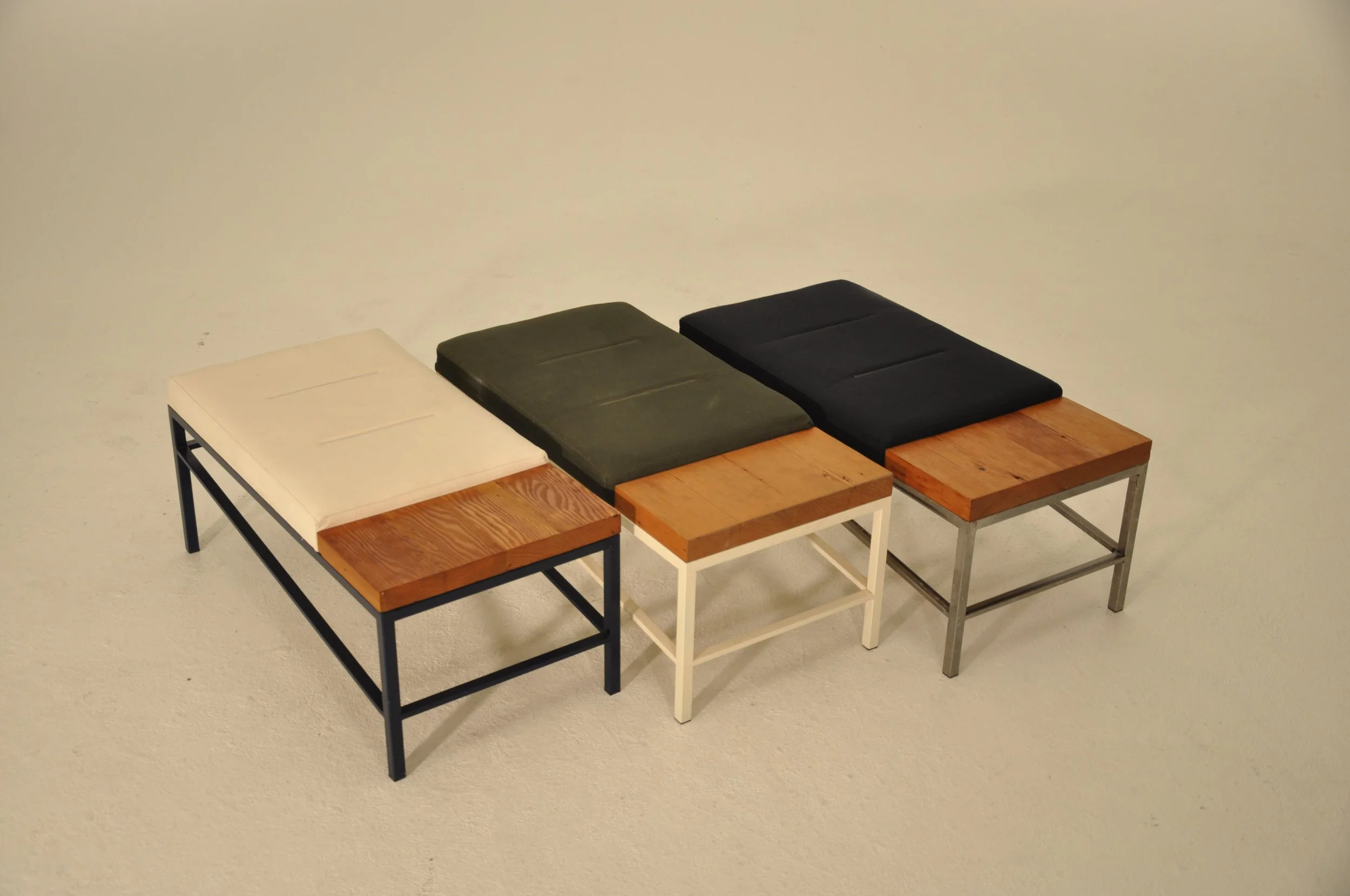 A set of five modern coffee tables with wooden tops and metal frames, arranged in a line against a plain white wall.