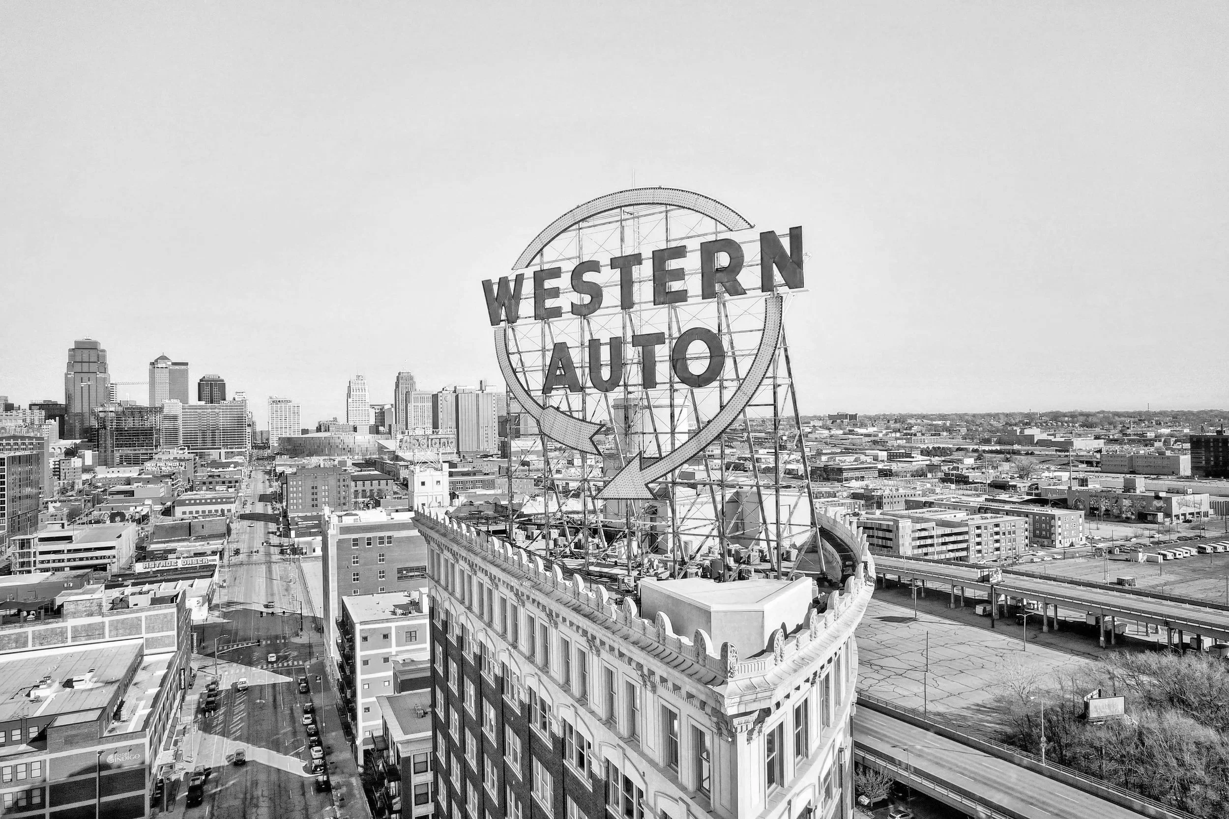 Kansas City skyline in black and white with a large sign reading 'Western Auto' on top of a building.