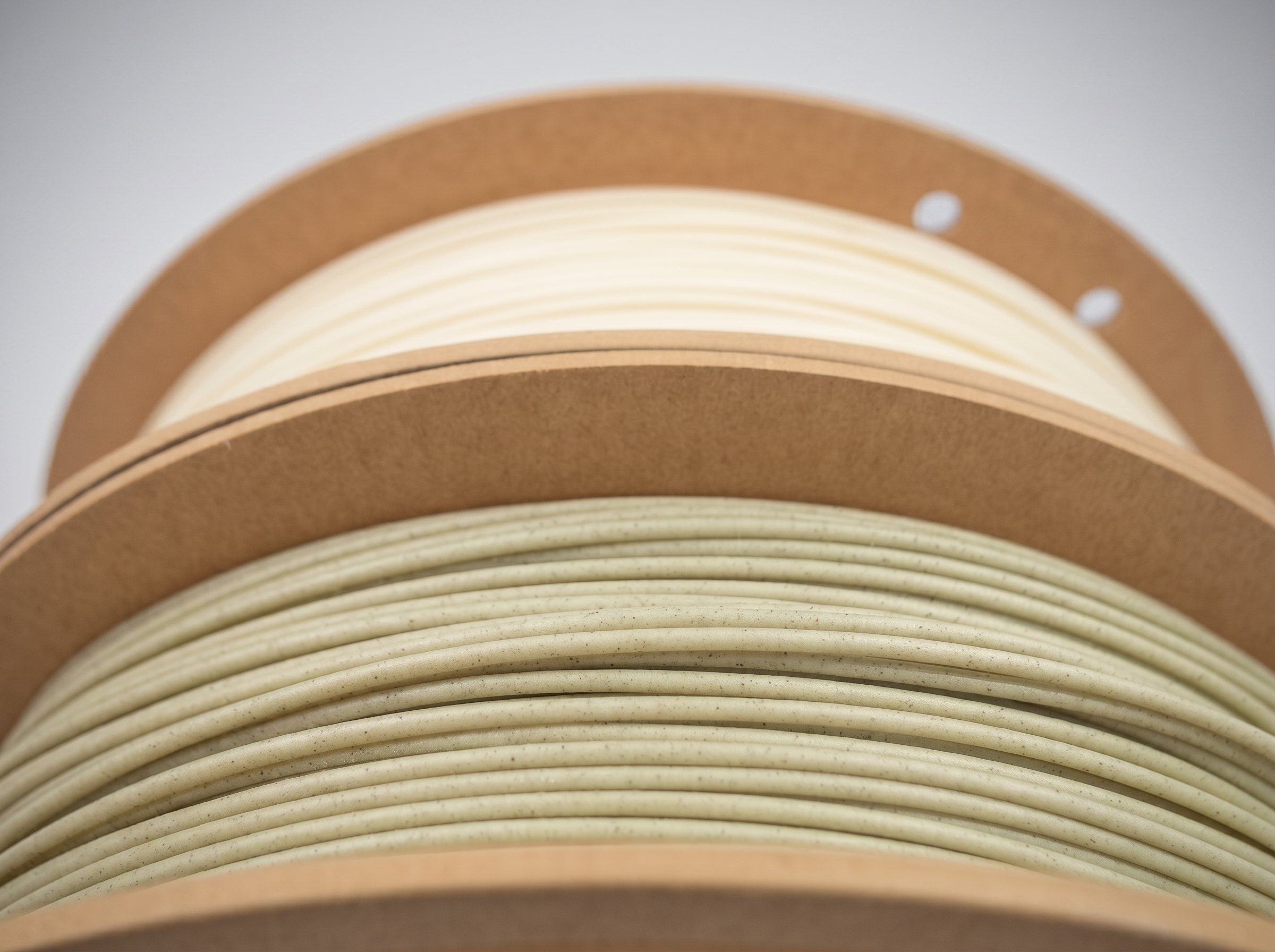 Close-up of stacked cardboard rings with some white and brown elements, creating a layered, rounded pattern.
