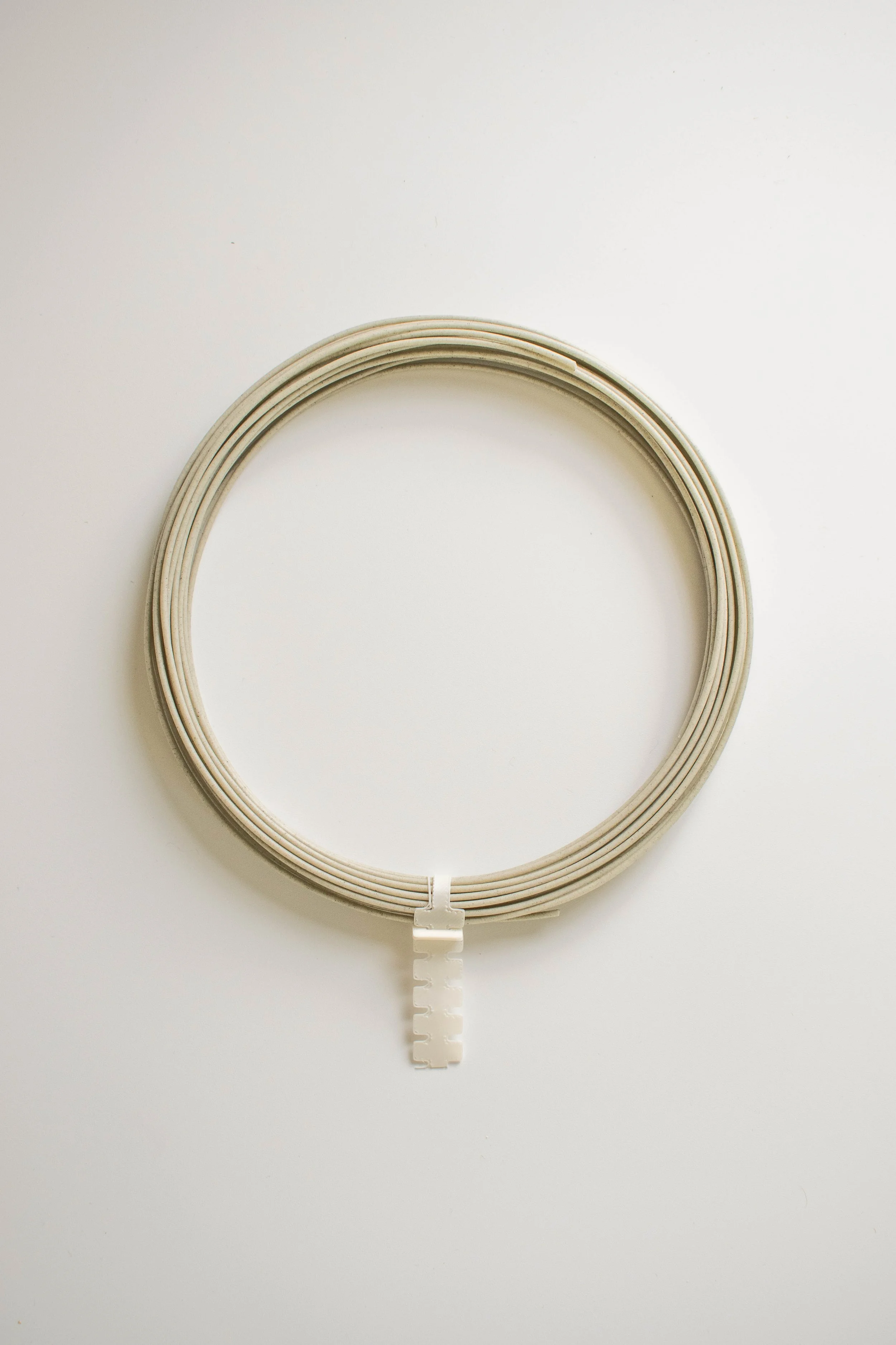 Seaweed Green TraceMatter™ trial filament arranged as a loose coil with a printed retaining clip