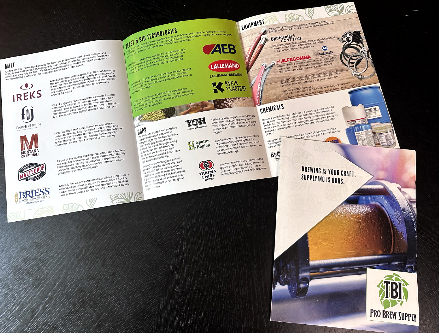 Open brochure and flyer on black table, showcasing brewing equipment, bottles, and brewery logos, with text about brewing technologies and ingredients.