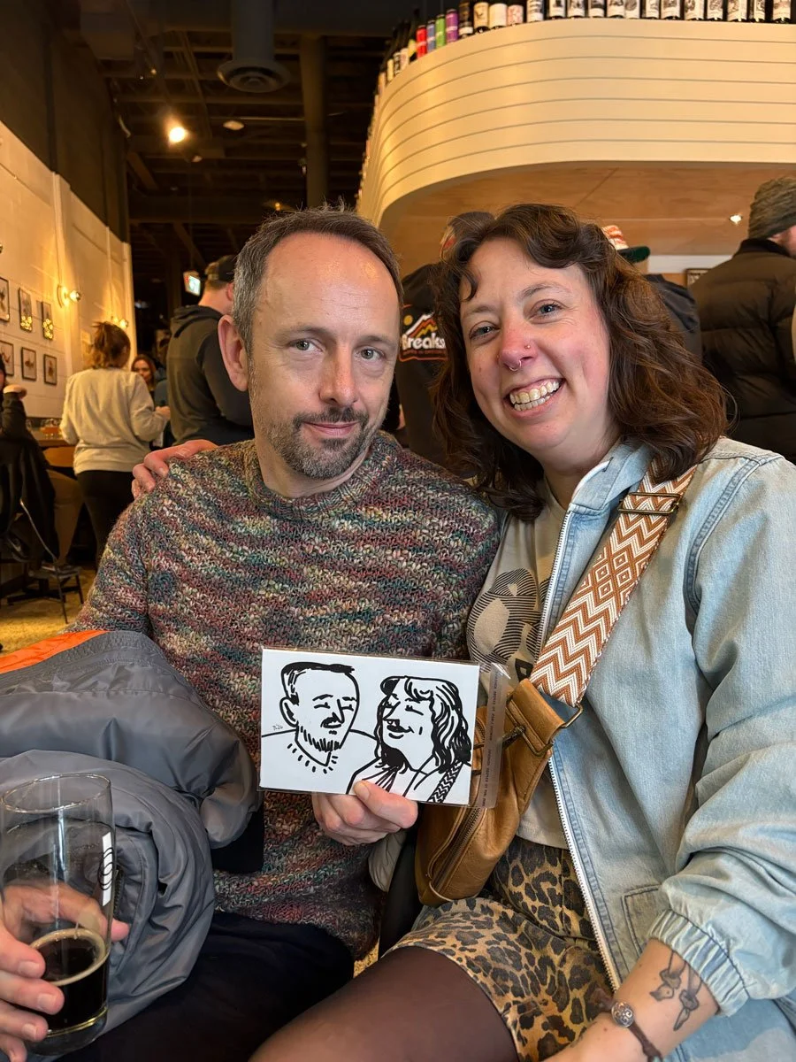 A coulple holding their derpy portrait, the woman seems to be more pleased than the man. 